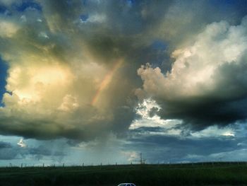 Scenic view of landscape against cloudy sky