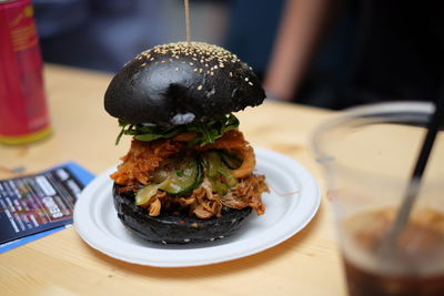 Burger served in plate on table at restaurant