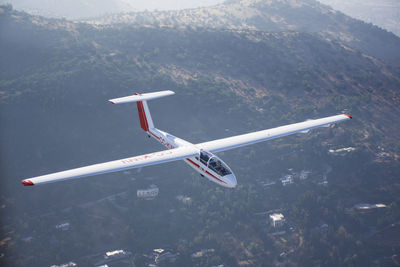 Airplane flying over mountain