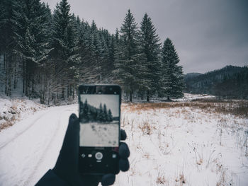 View of camera and cars on snow covered land