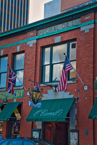 Low angle view of flag against buildings in city