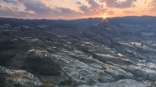 Aerial view of landscape against sky during sunset