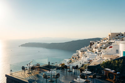 High angle view of townscape by sea against clear sky
