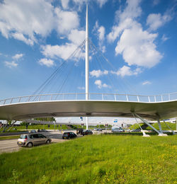 View of suspension bridge against cloudy sky