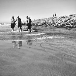 Rear view of man walking on beach