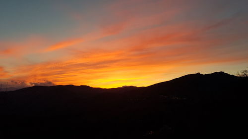 Scenic view of silhouette mountains against sky during sunset