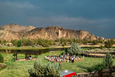 Group of people on mountain against sky