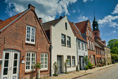 Low angle view of buildings in town against sky