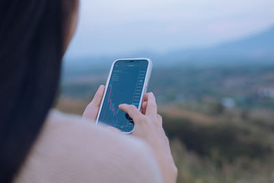 Midsection of woman using mobile phone