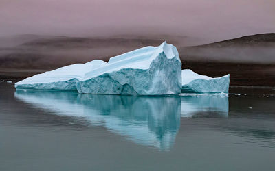 Scenic view of frozen lake against sky during winter