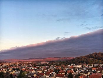 Townscape against sky during sunset