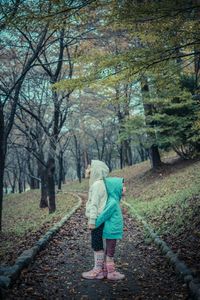 Full length of woman standing on footpath