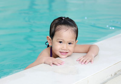 Portrait of cute girl in swimming pool