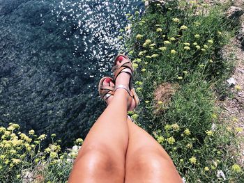 Low section of woman relaxing on water