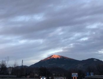 Scenic view of mountains against storm clouds