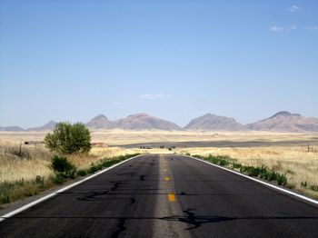 Road in desert against clear sky