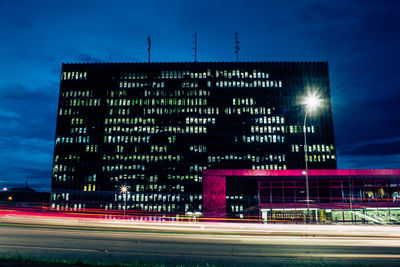 Light trails on road against sky at night