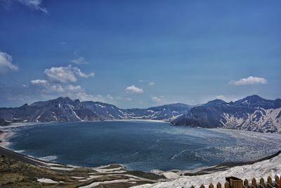 Scenic view of heaven lake by mountains against sky during winter