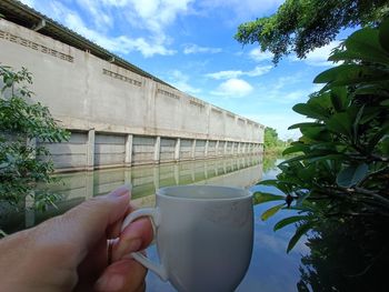 Cropped hand holding coffee