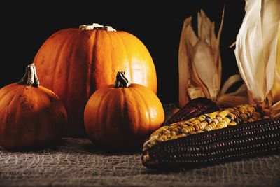 Close-up of pumpkins on table against black background