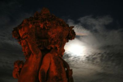 Low angle view of silhouette woman against sky