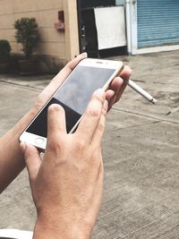 Close-up of man using mobile phone on table