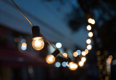 Low angle view of illuminated light bulbs