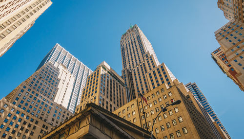 Low angle view of buildings against clear blue sky