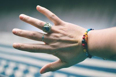 Close-up of woman hand against blurred background