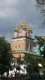 Low angle view of building against cloudy sky