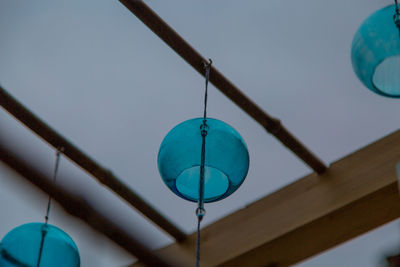 Low angle view of lighting equipment hanging from ceiling