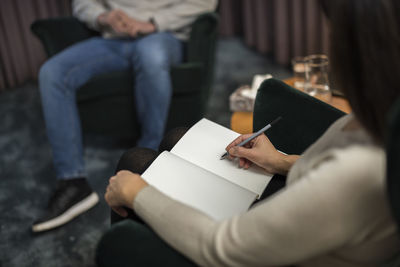 Female doctor taking notes at therapy session