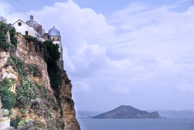 Scenic view of sea and buildings against sky