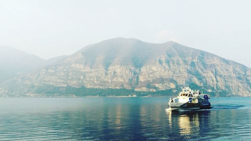 Scenic view of sea and mountains against sky