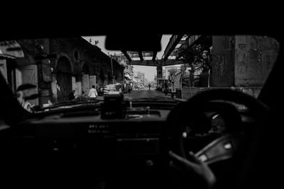 Car in city seen through windshield