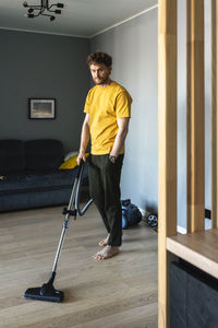 Full length of young man standing at home