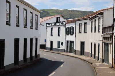 Road by building against sky