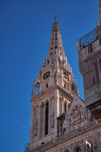 Low angle view of historic building against clear blue sky