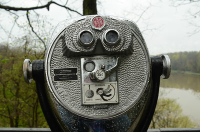 Outdoor coin operated binoculars overlooking lake