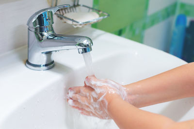 Midsection of woman in bathroom at home