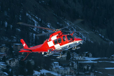 A rescue helicopter flying in st moritz switzerland