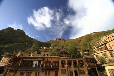 Residential buildings in town against sky