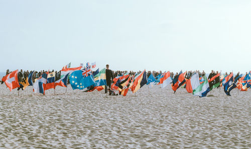 Multi colored umbrellas on beach against clear sky