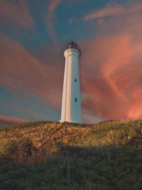 Low angle view of lighthouse against sky during sunset