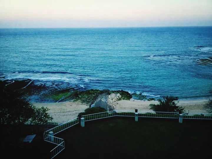 sea, water, horizon over water, tranquil scene, scenics, tranquility, beauty in nature, nature, railing, sky, idyllic, seascape, calm, high angle view, rippled, blue, ocean, beach, remote, no people