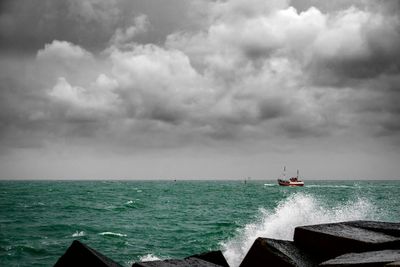 Scenic view of sea against storm clouds