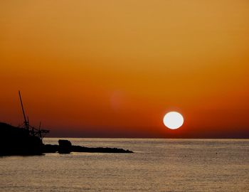 Scenic view of sea against orange sky