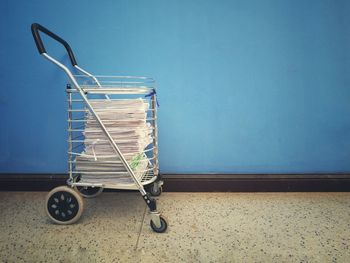 Side view of a bicycle against blue wall