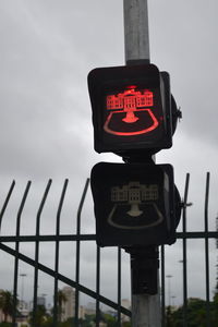Low angle view of road sign against sky