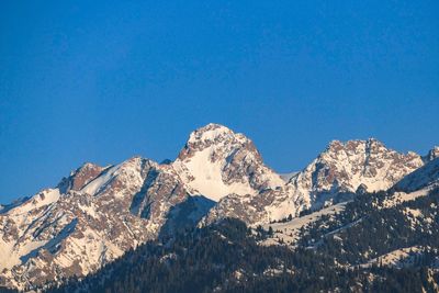 Low angle view of mountain against clear blue sky